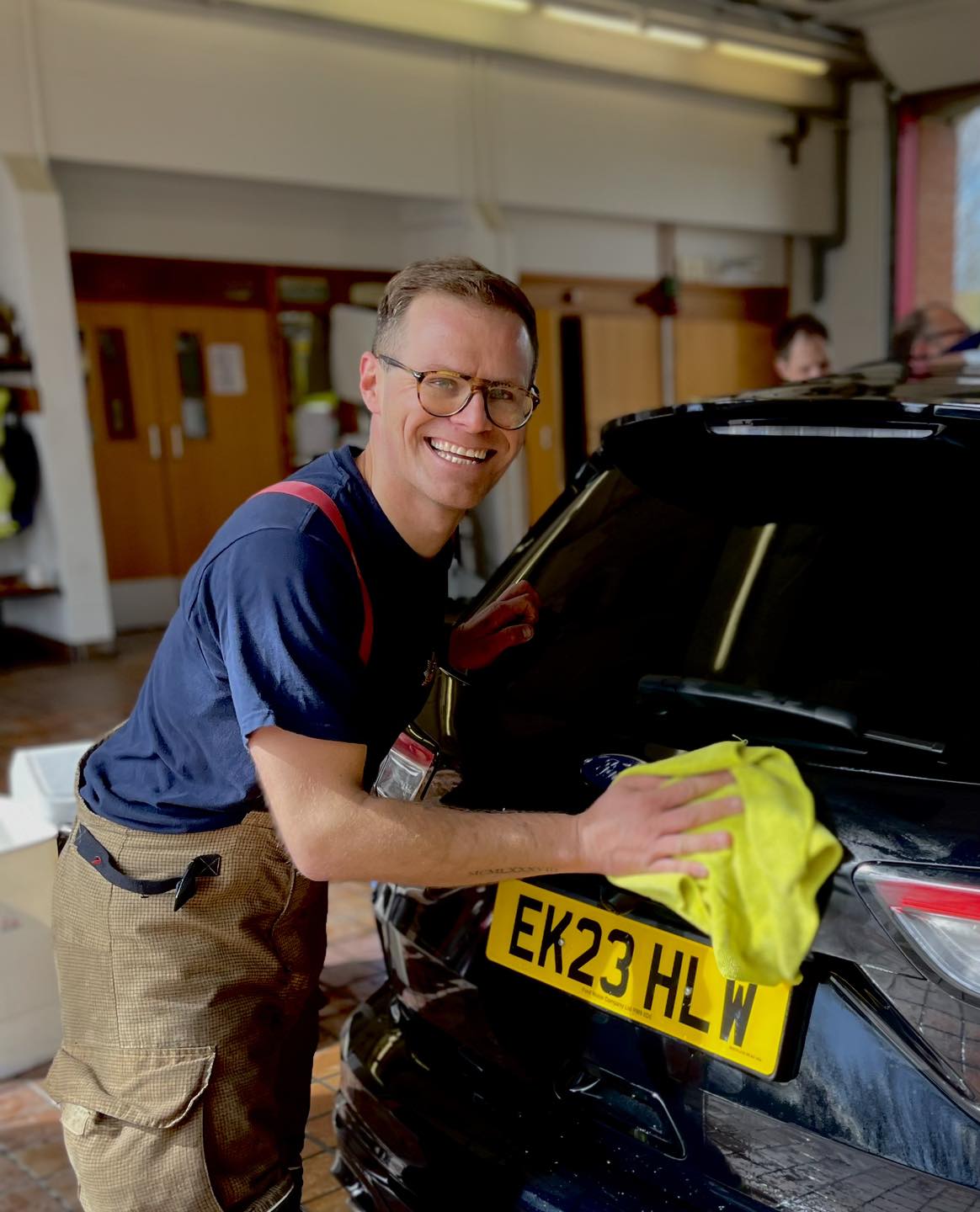 Firefighter Chris Kirby from Maldon Fire Station washing a car