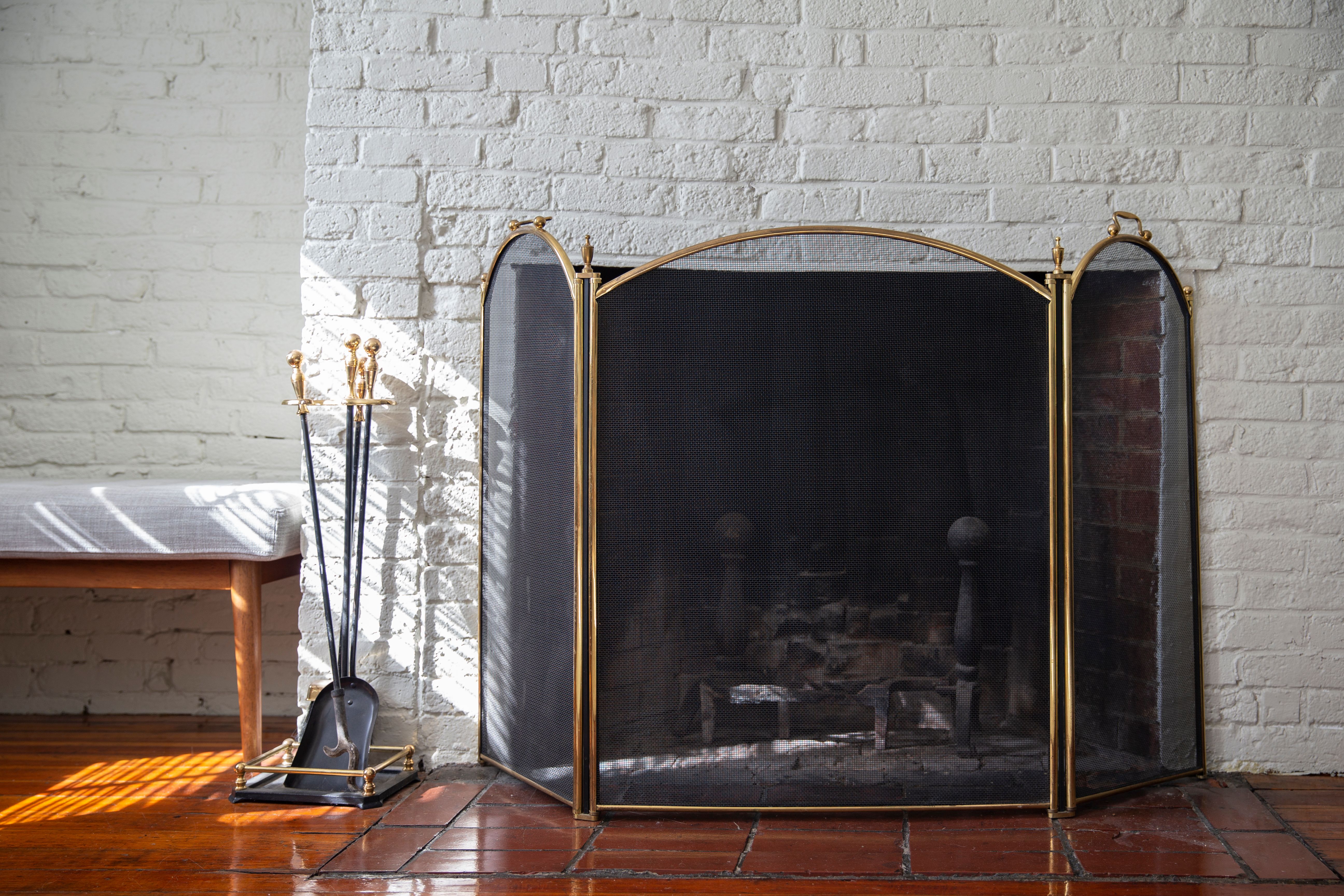 White brick chimney breast with open fireplace and fire guard 