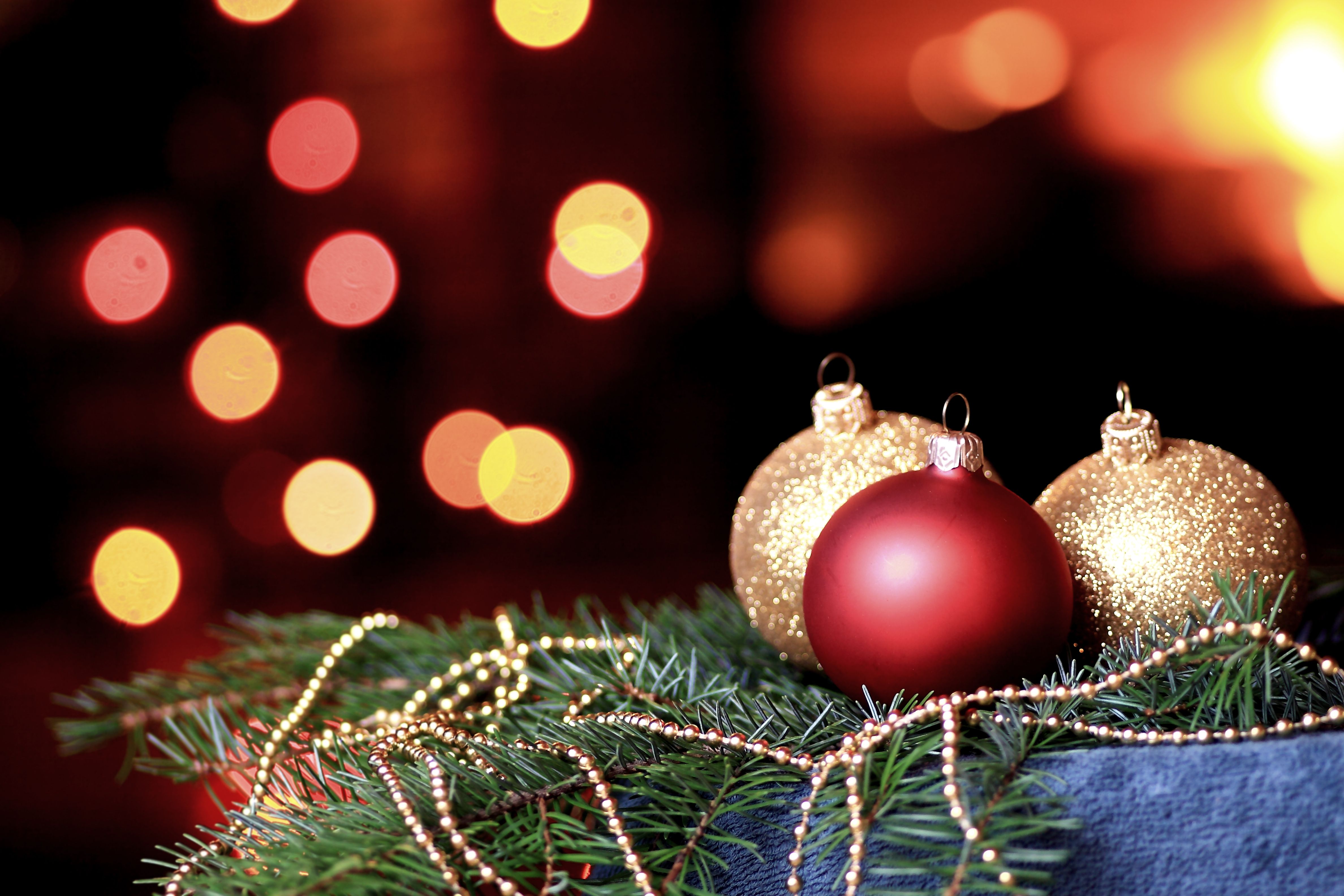 Gold and Red baubles surrounded by Christmas lights with gold beads