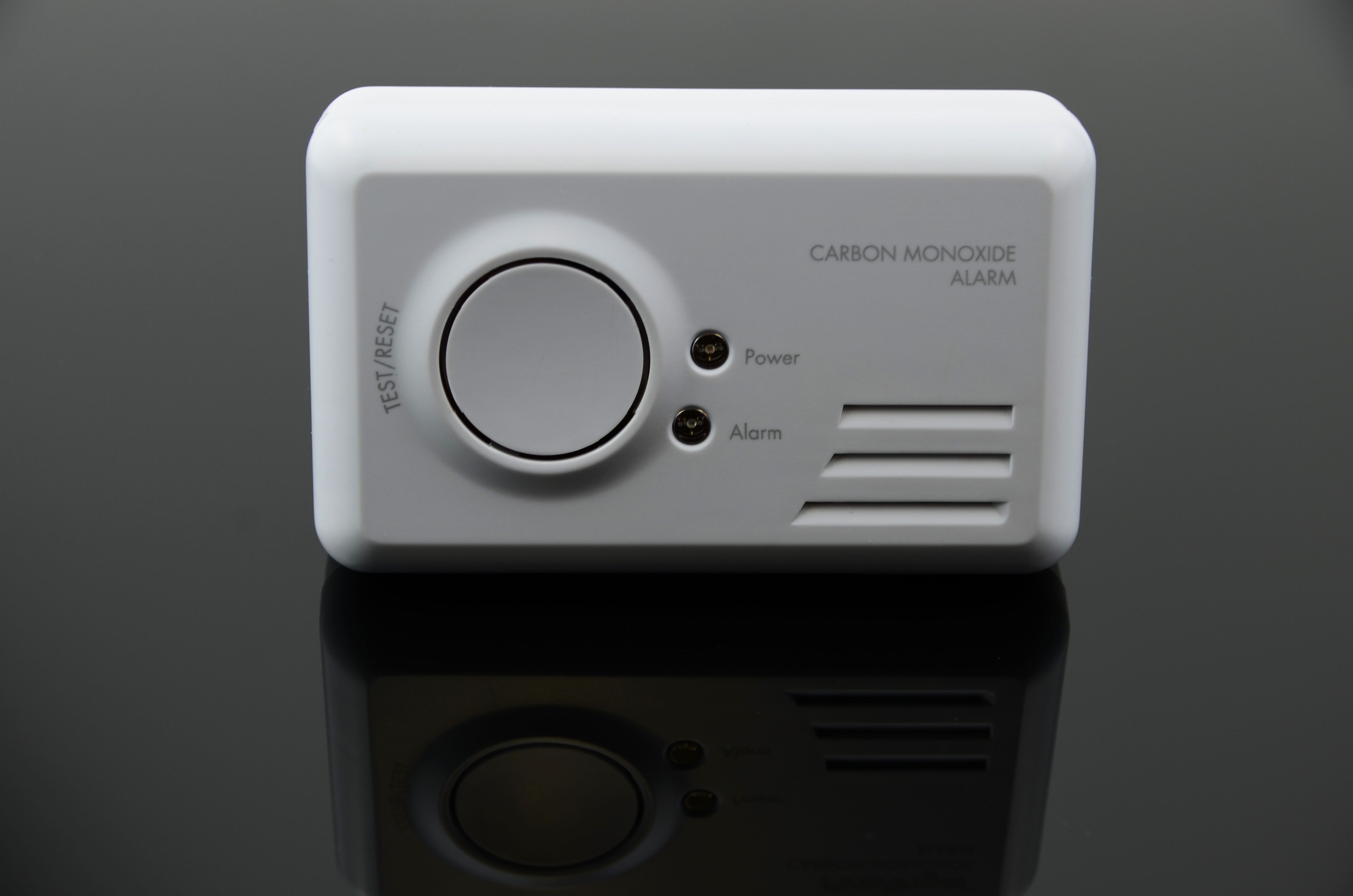 Standard Carbon Monoxide Detector placed on black reflective surface