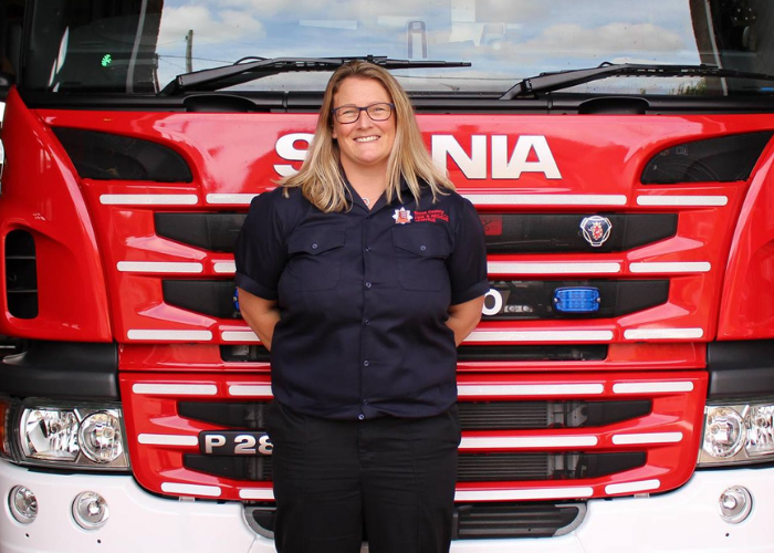 Station Manager Karen Nicoll standing in front of a fire engine