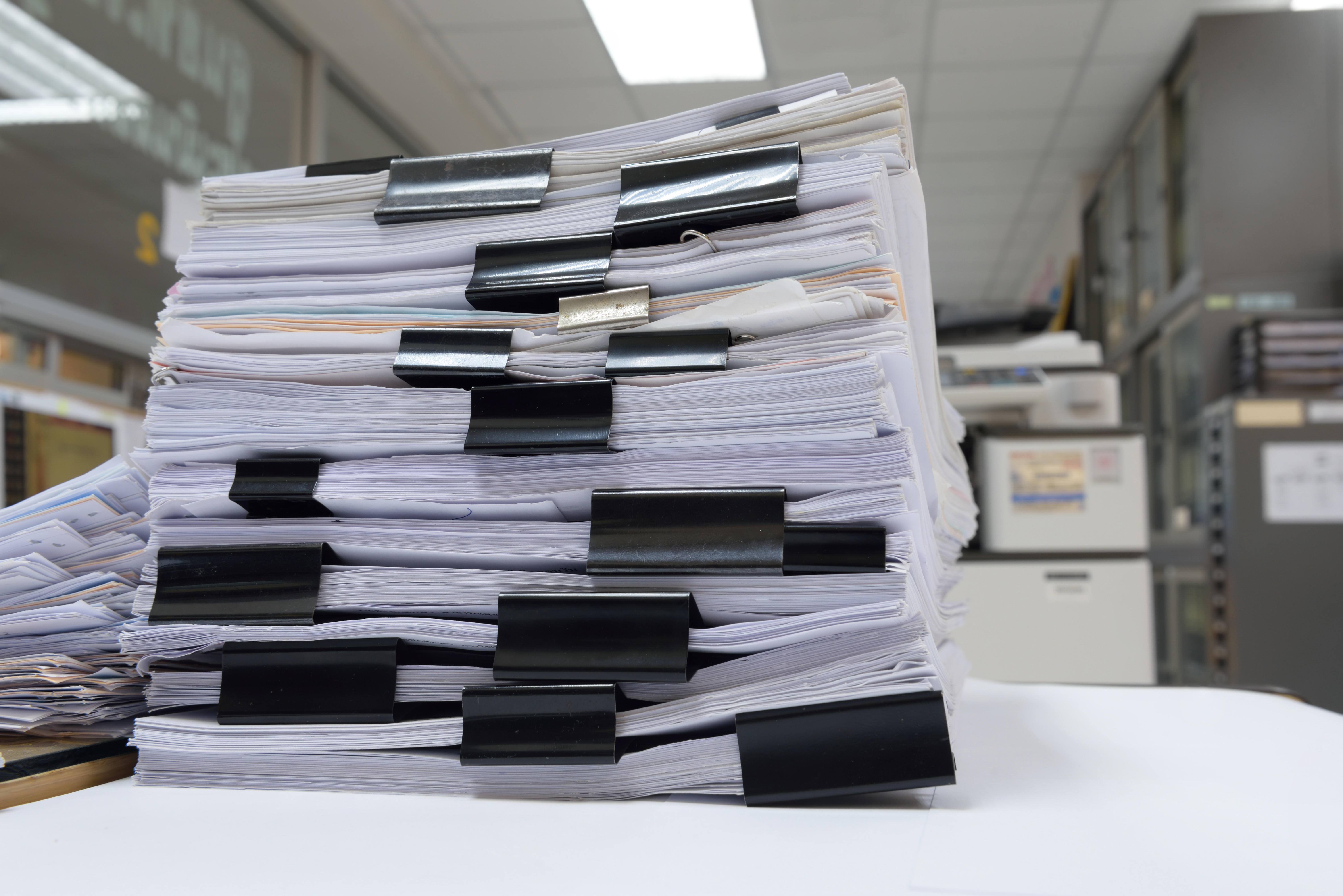 Pile of papers, separated by bulldog clips