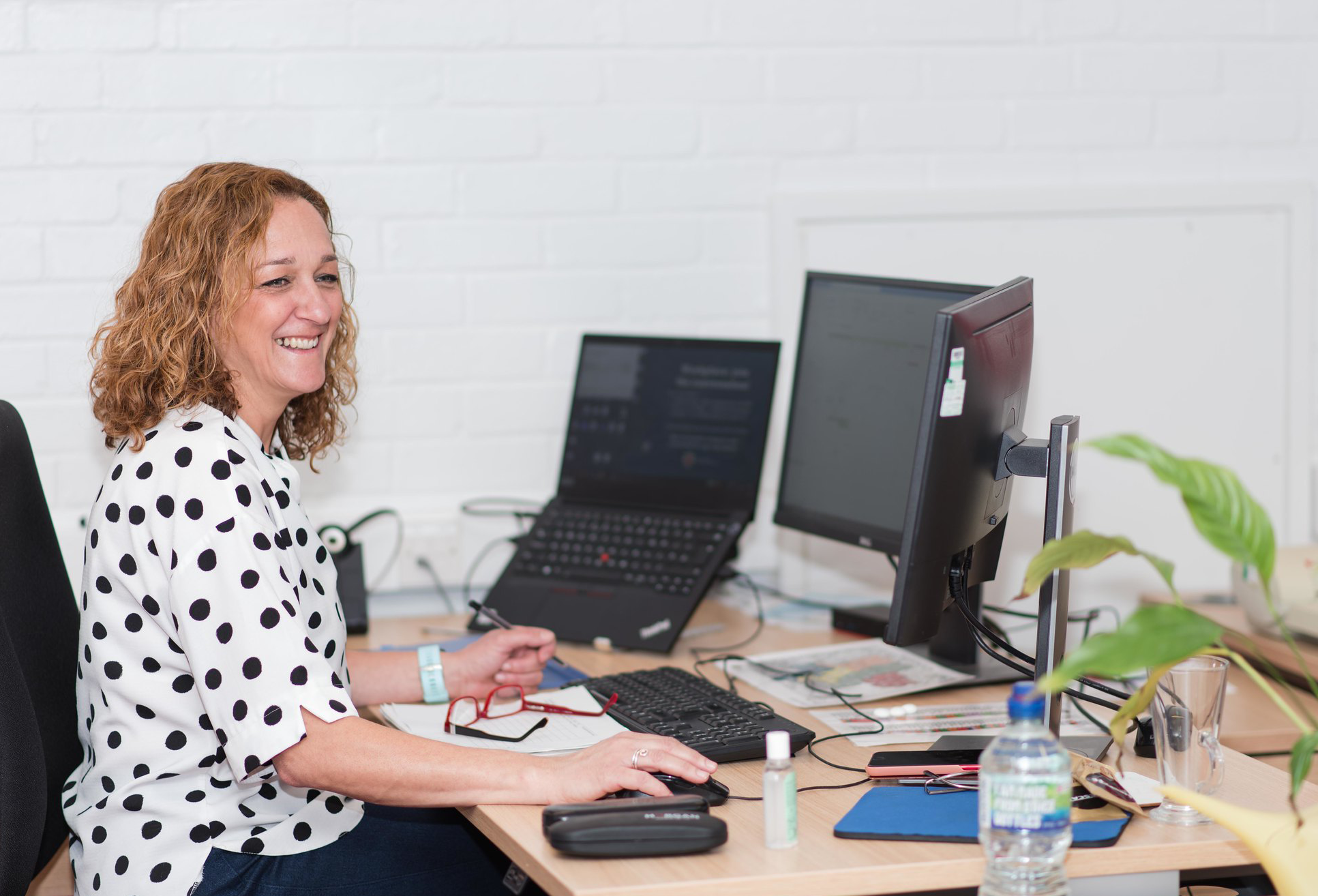 Lady smiling at computer screen