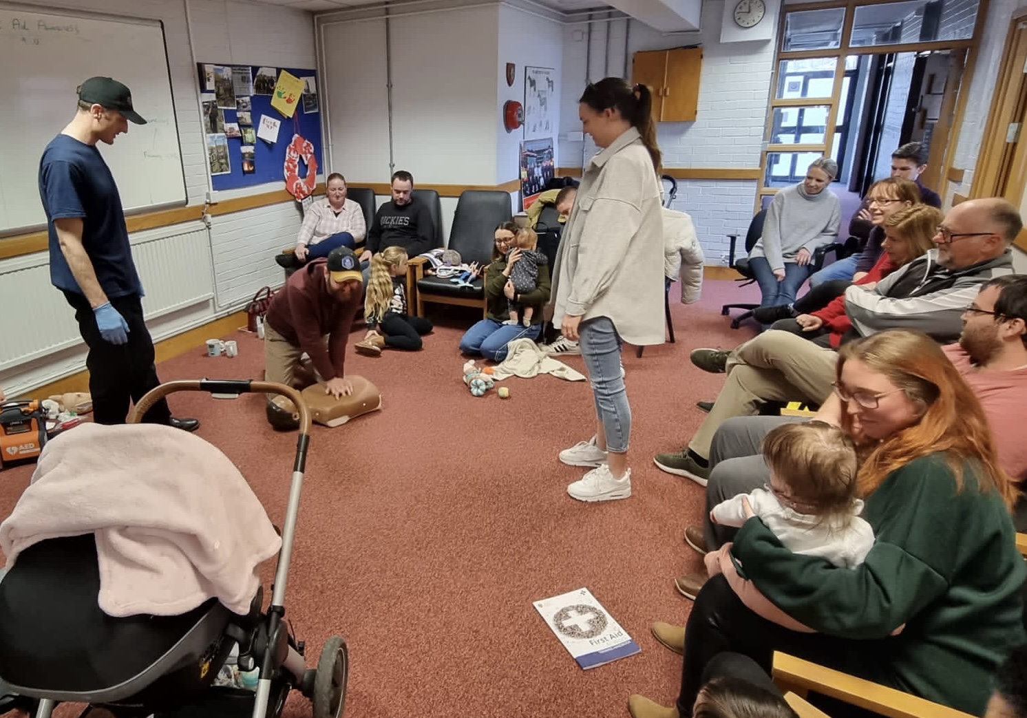 Firefighters giving first aid training inside fire station