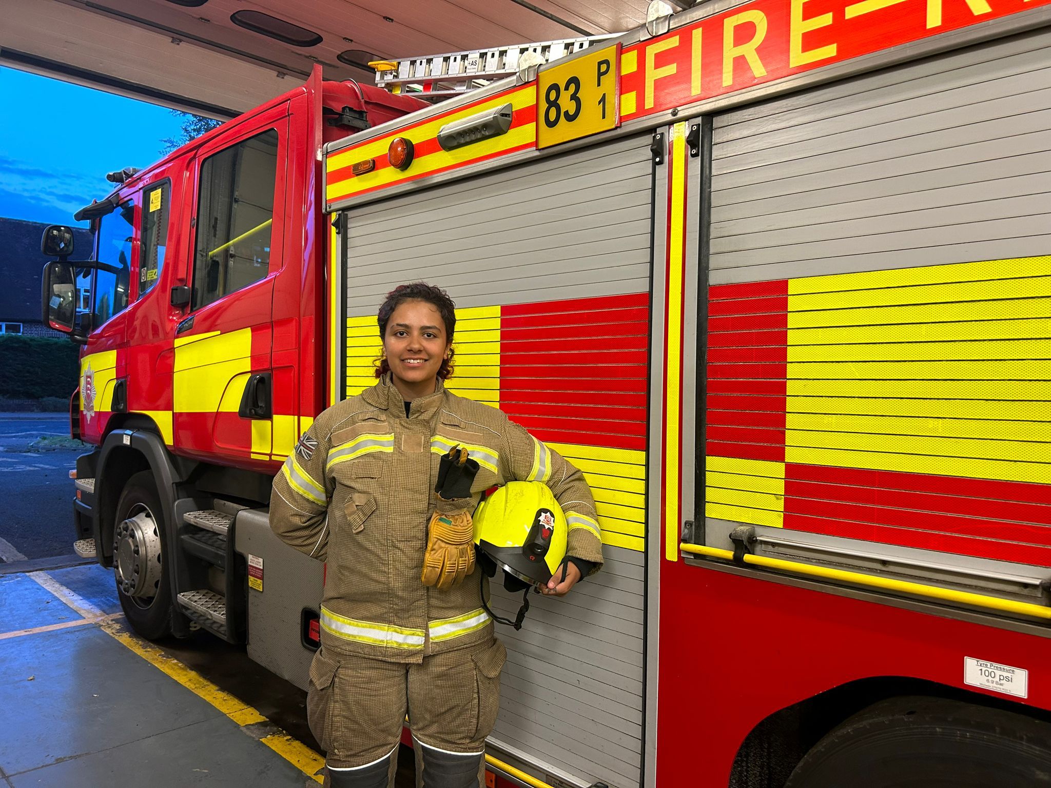 Firefighter Keegan Johnson in front of a fire engine at Stansted Fire Station