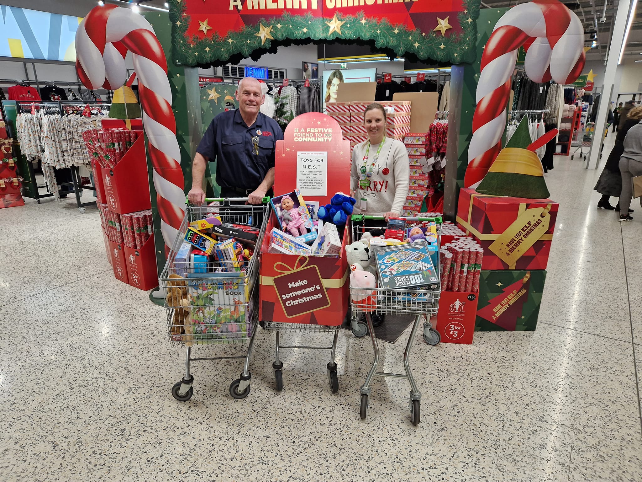 Les Nicoll with volunteer shopping for Christmas hamper donations