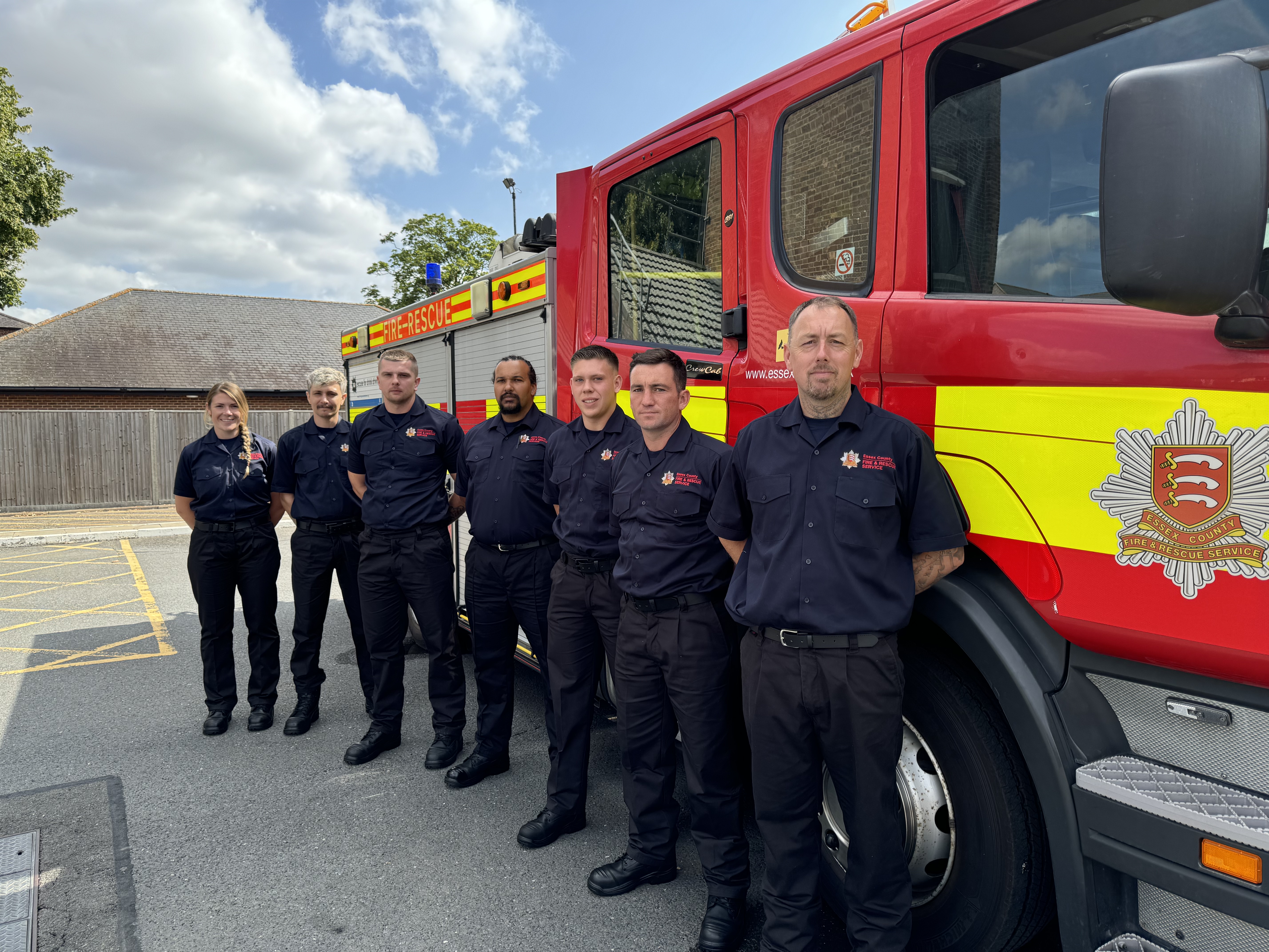 Seven new on-call firefighters in front of a fire engine