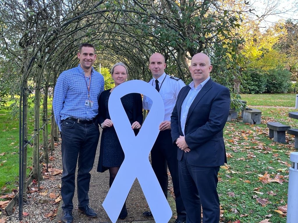 Members of our Service Leadership Team holding a white ribbon for White Ribbon Day 2022