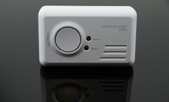 Standard Carbon Monoxide Detector placed on black reflective surface