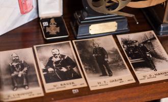 Old photos of former firefighters laid out on a table. 