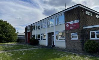 Brick fire station building with grass at the front