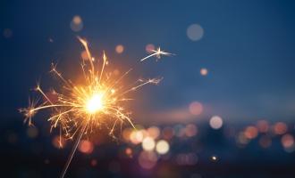 Close up of lit sparkler against blue dusky sky