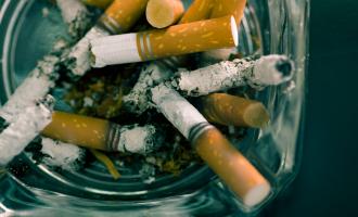 Series of cigarette butts in glass ashtray