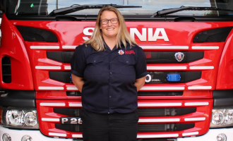Station Manager Karen Nicoll standing in front of a fire engine