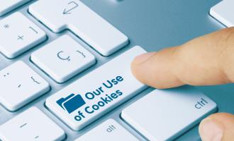 finger clicking keyboard button that says 'our use of cookies'