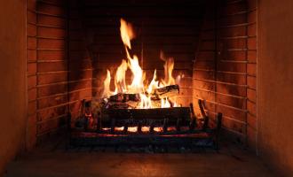 Logs in open fire place, large fire burning