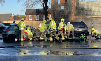 Firefighter carrying out a road traffic collision training drill
