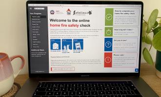 A laptop with the online home fire safety check page open