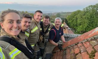 Five members of Manningtree's crew on top of the church roof