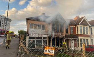 A disused building with smoke coming from it following a fire