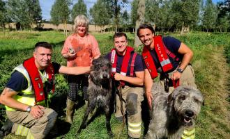 Firefighters with Wallace and his owner Judy