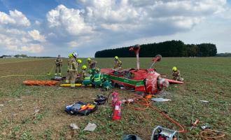 An aircraft crashed in the middle of a field with firefighters and paramedics around it