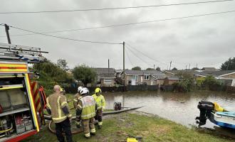 Firefighters working to pump floodwater away from houses in St Osyth