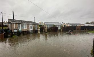 Firefighters working to pump floodwater away from houses in St Osyth