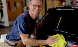 Firefighter Chris Kirby from Maldon Fire Station washing a car