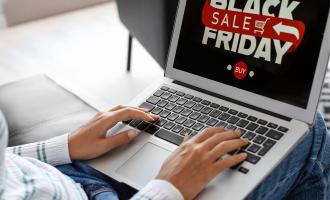 Person typing on laptop which reads 'Black Friday Sales'