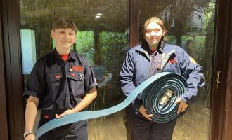 Zak and Jorge with a reel of old fire hose at Colchester Zoo