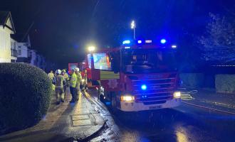 Firefighters with engines in front of house at an incident