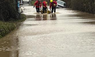Crews rescuing a person from a car trapped in floodwater in Great Horkesley