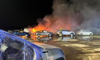 Firefighters tackling cars on fire