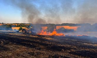 Farmers working with crews at a stack fire in Kelvedon Hatch