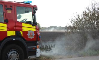 A fire engine at the scene of a field fire in Rochford