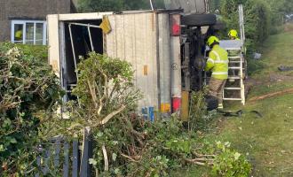 Firefighters working to rescue a man and a dog from a van following a road traffic collision