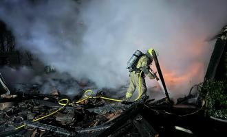 Firefighter extinguishing garage on fire