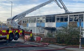ALP set up next to derelict building which is on fire