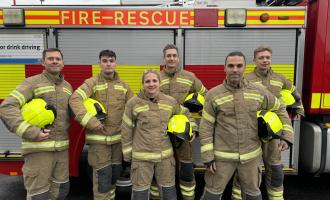 Six new on-call firefighters stand infront of fire engine