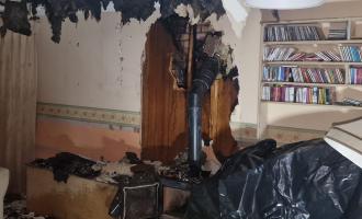 A burnt out living room with a log burner