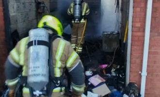 Firefighters in the burnt out garage