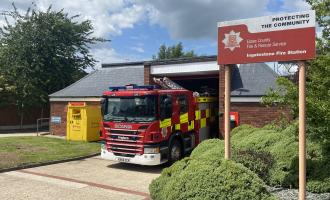 Ingatestone fire station, with a fire engine parked out the front and the sign at the front of the photo
