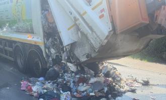 Burnt rubbish on the ground, coming out of the back of a bin lorry