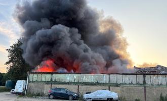 Fire and smoke billowing from a warehouse