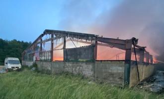 A barn consumed in fire and smoke