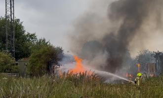 A firefighter spraying water on flames