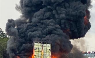 A lorry and its load of tyres alight, producing thick black smoke