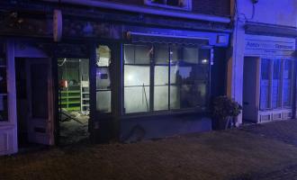 The outside of the shop, with flats above