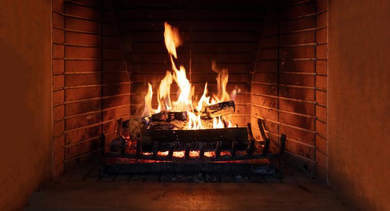 Logs in open fire place, large fire burning